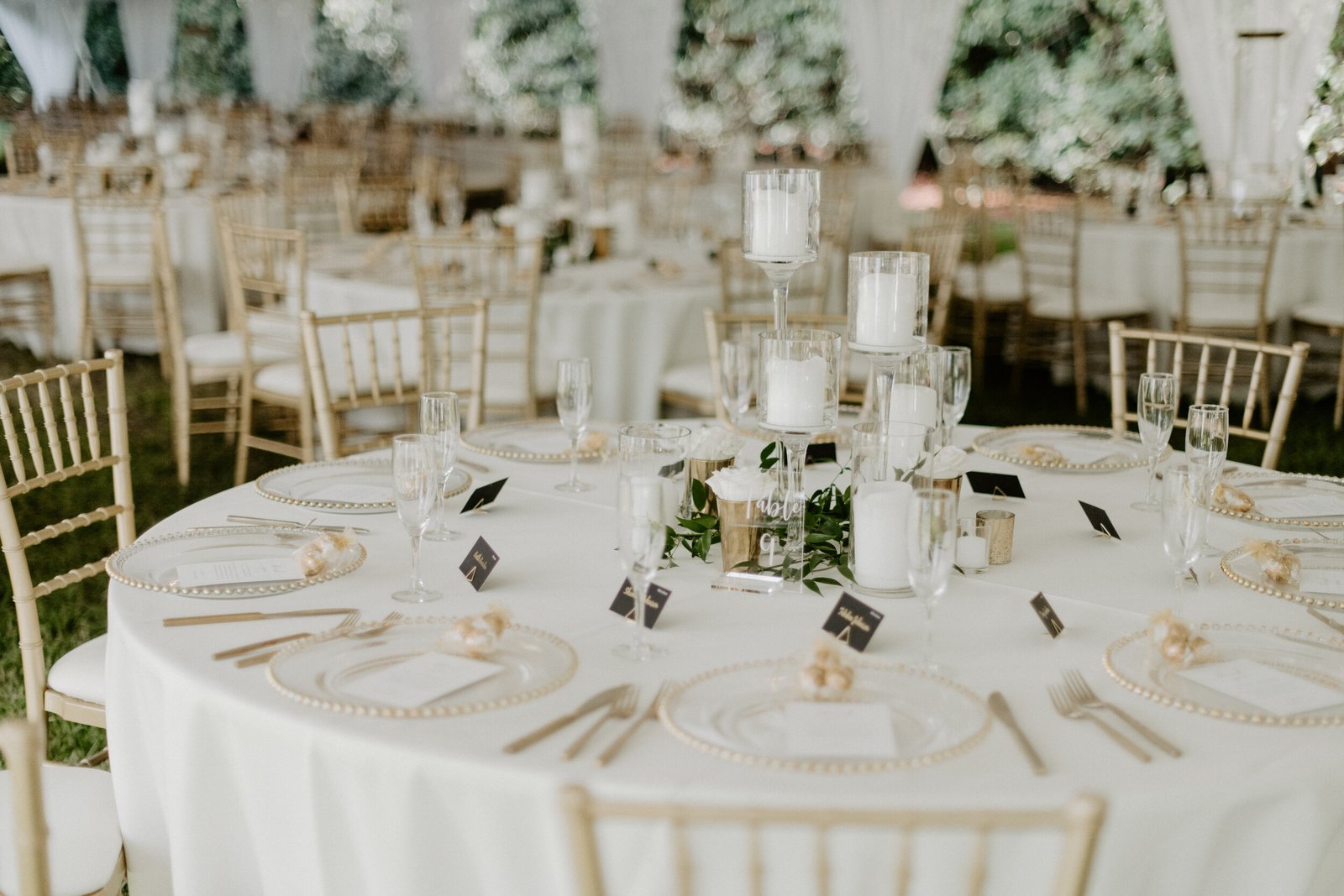 round table gold chiavari white florals place cards