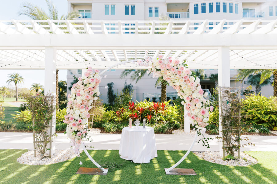 Outdoor wedding ceremony flower arch, created for event rentals in Tampa FL by Gabro Event Services.