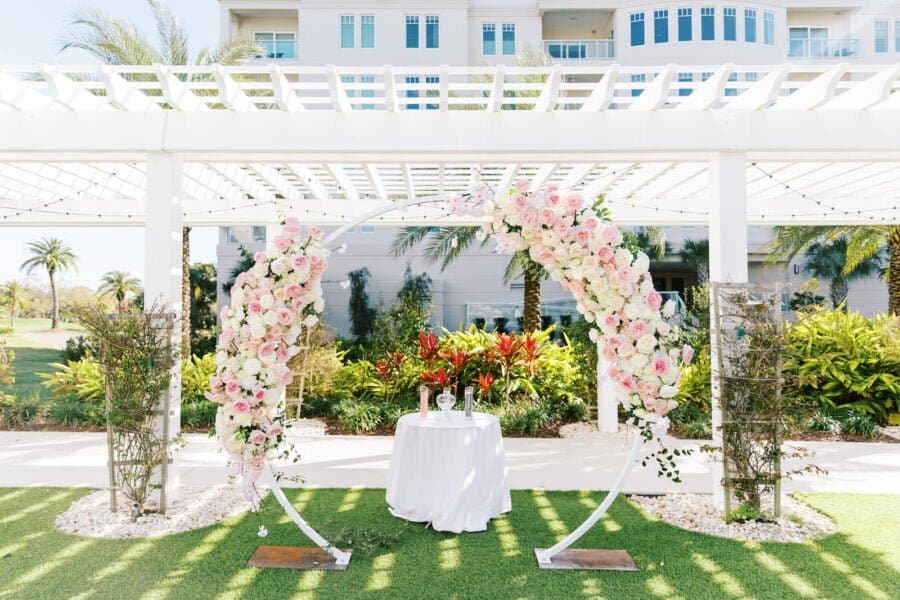 Outdoor wedding ceremony flower arch, created for event rentals in Tampa FL by Gabro Event Services.