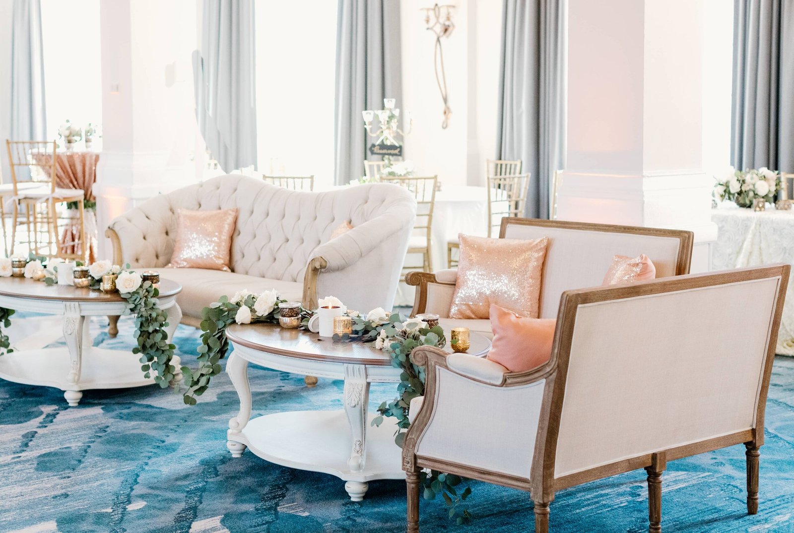 blush white lounge teal rug greenery