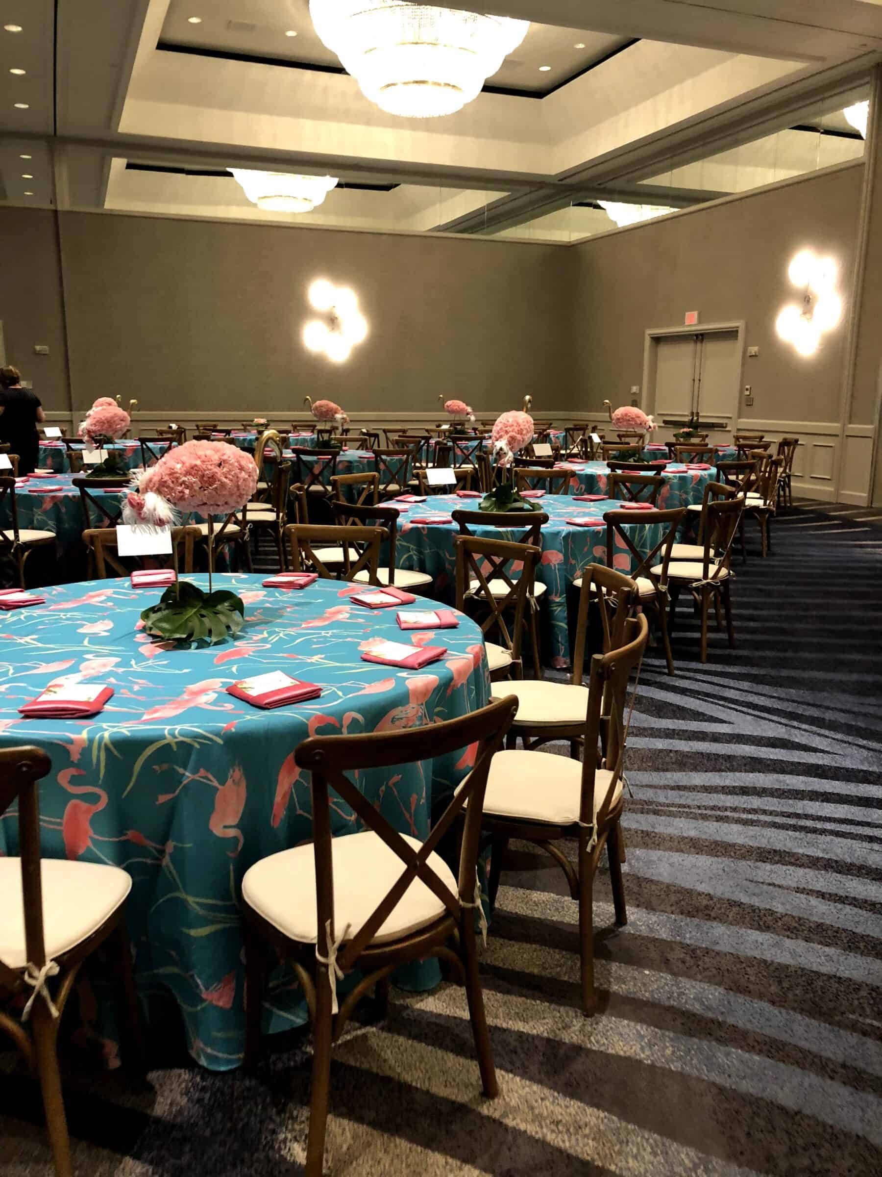 Corporate Event Dining Setup | Gabro Event Services Corporate dining setup with teal linens, floral centerpieces, and wooden chairs designed by Gabro Event Services in Tampa Bay.