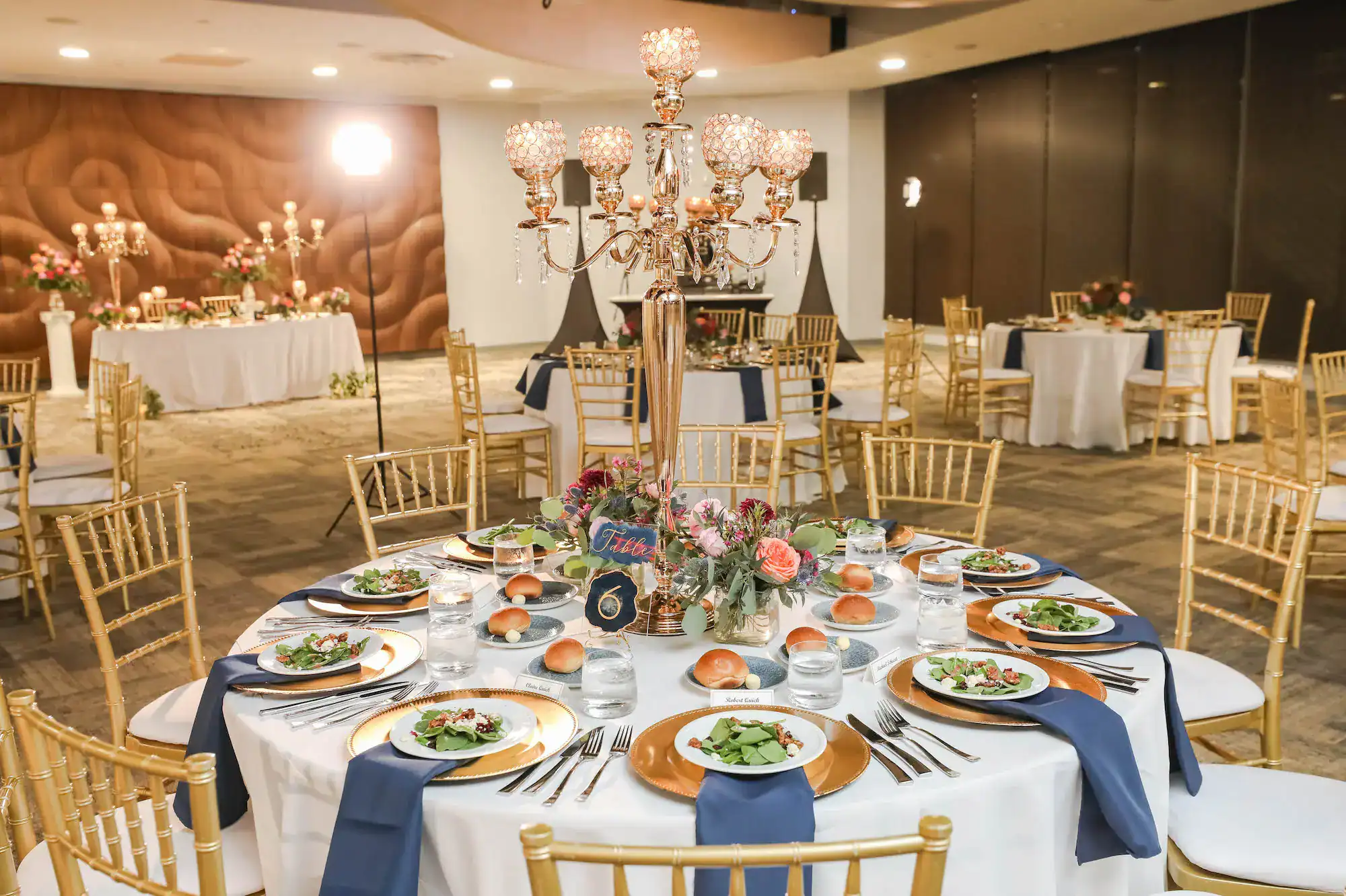 Reception tables styled with blue-accented wedding details