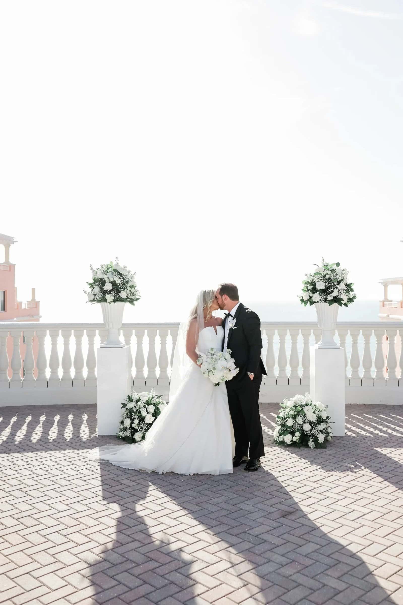 Newlyweds kissing on the oceanview balcony after their Clearwater Beach ceremony