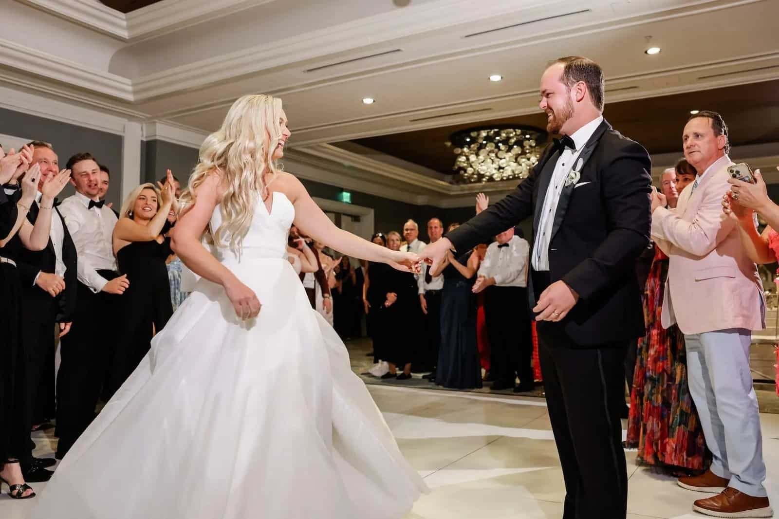 Bride and groom first dance on the white dance floor