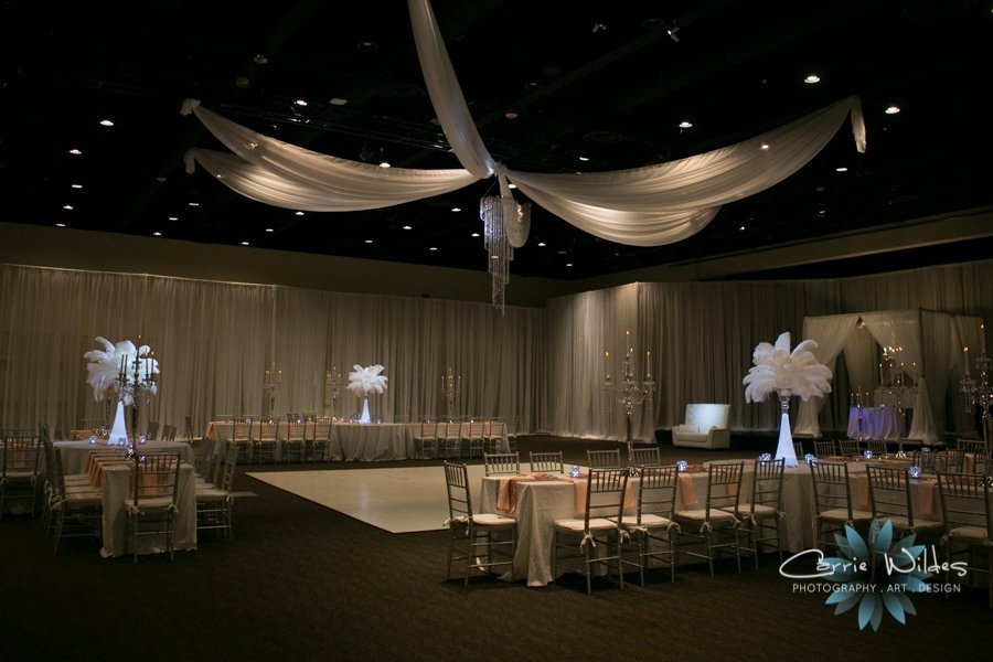 Grand wedding reception ballroom at A La Carte Pavilion featuring Gabro Event Services custom ceiling fabric treatments and crystal chandeliers