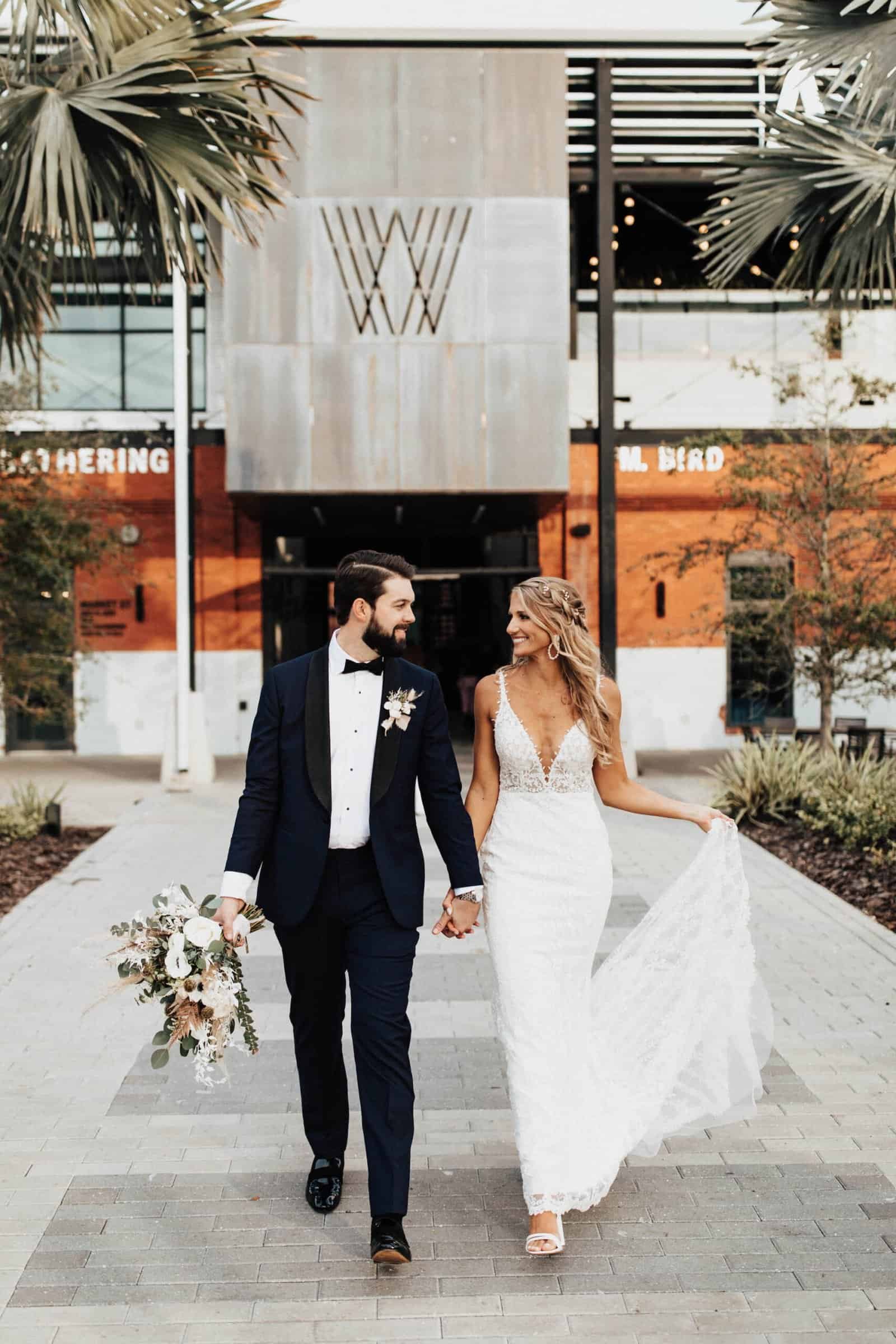 Elegant indoor wedding reception at Armature Works featuring white and gold table decor.