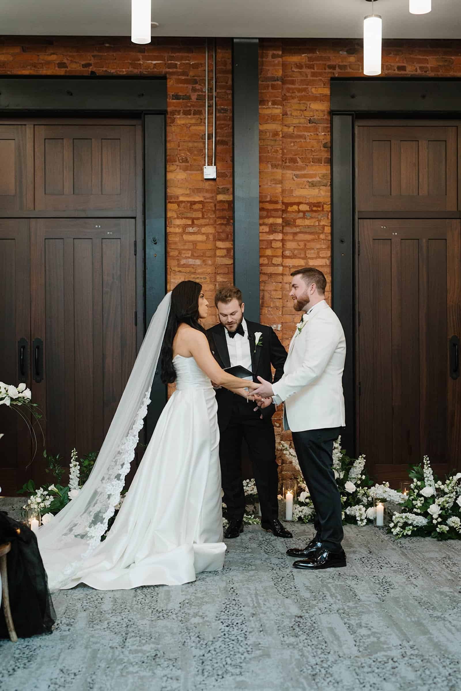 The bride and groom dancing on a classic black and white checkered floor.