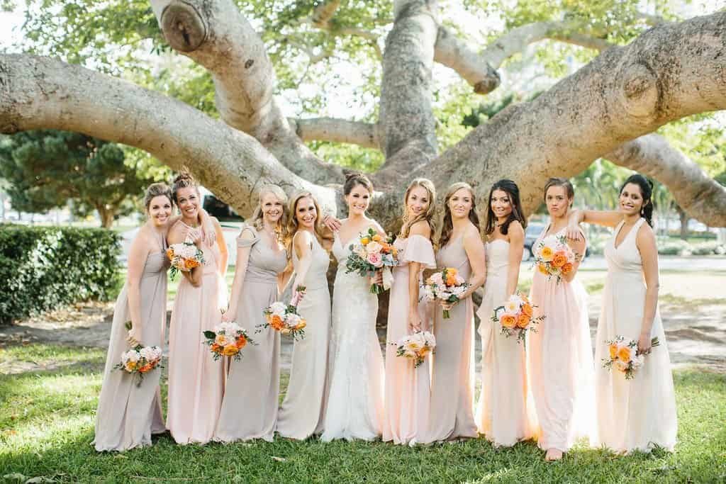 Bride in Watters Bridal Gown with Bridesmaids in Mismatched Blush Pink and Champagne Dresses by CCs Boutique