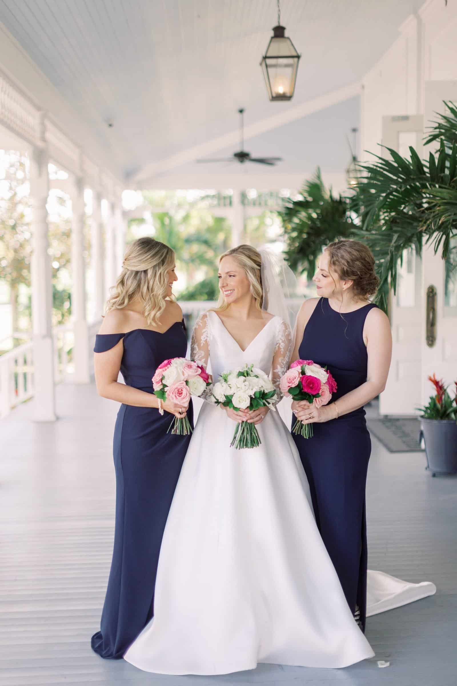 Grand reception tent interior featuring draped ceiling and suspended greenery chandeliers