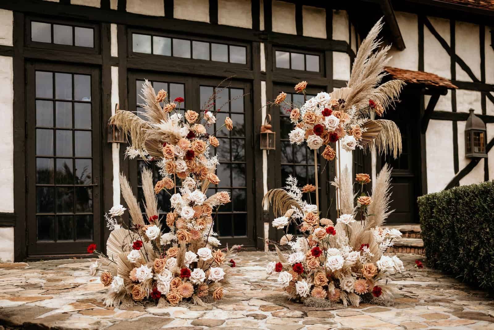 Long farmhouse tables decorated with crystal chandeliers and elegant gold rimmed glassware.