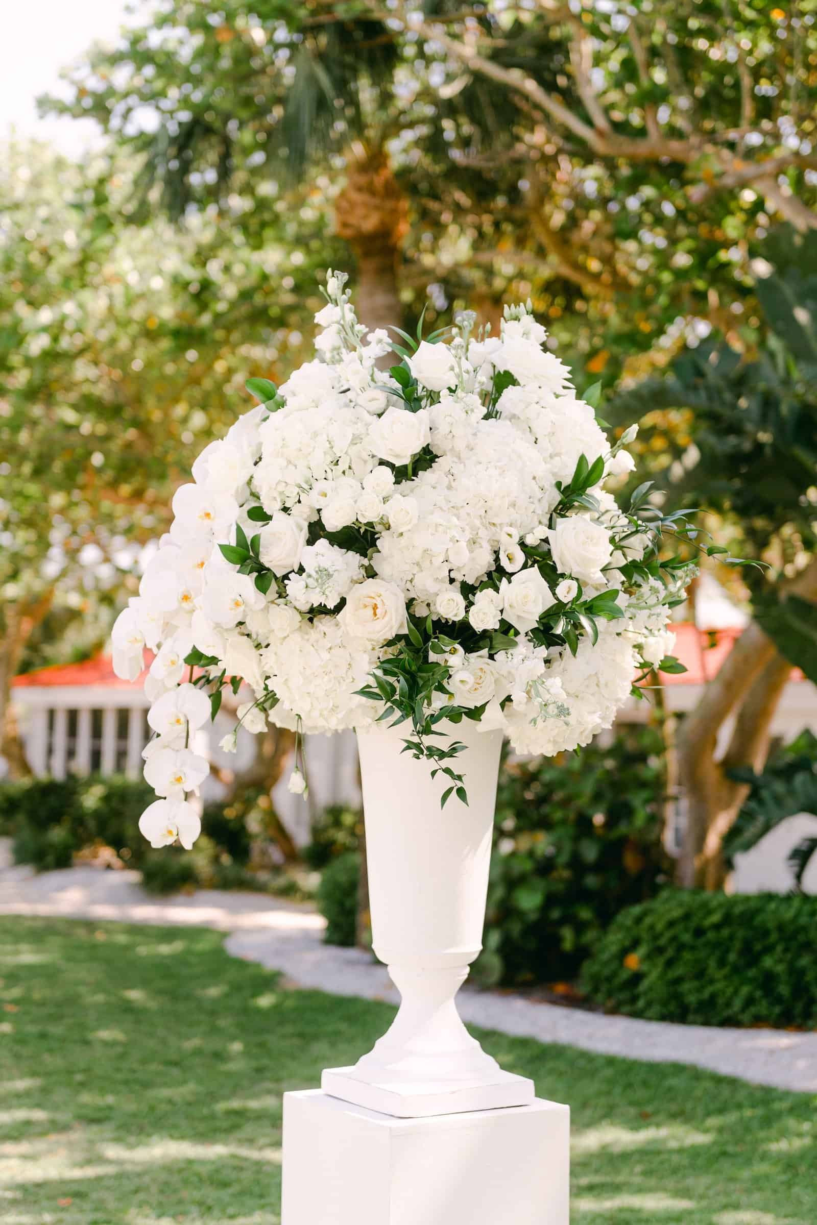 A refined indoor reception space with glowing candles and silver tabletop decor elements.