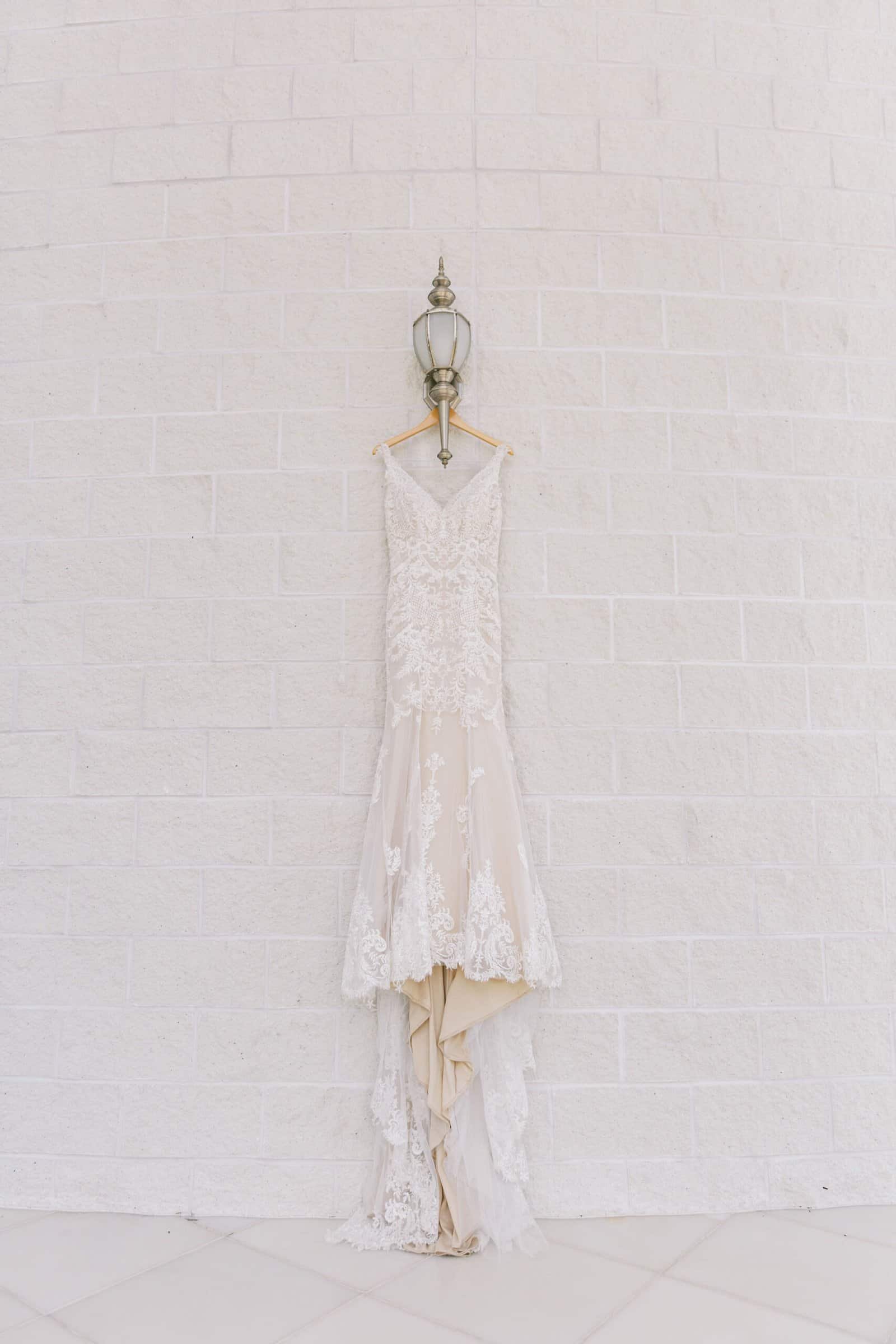Historic courtyard terrace ceremony with custom guest seating and ornate floral arches at The Vinoy