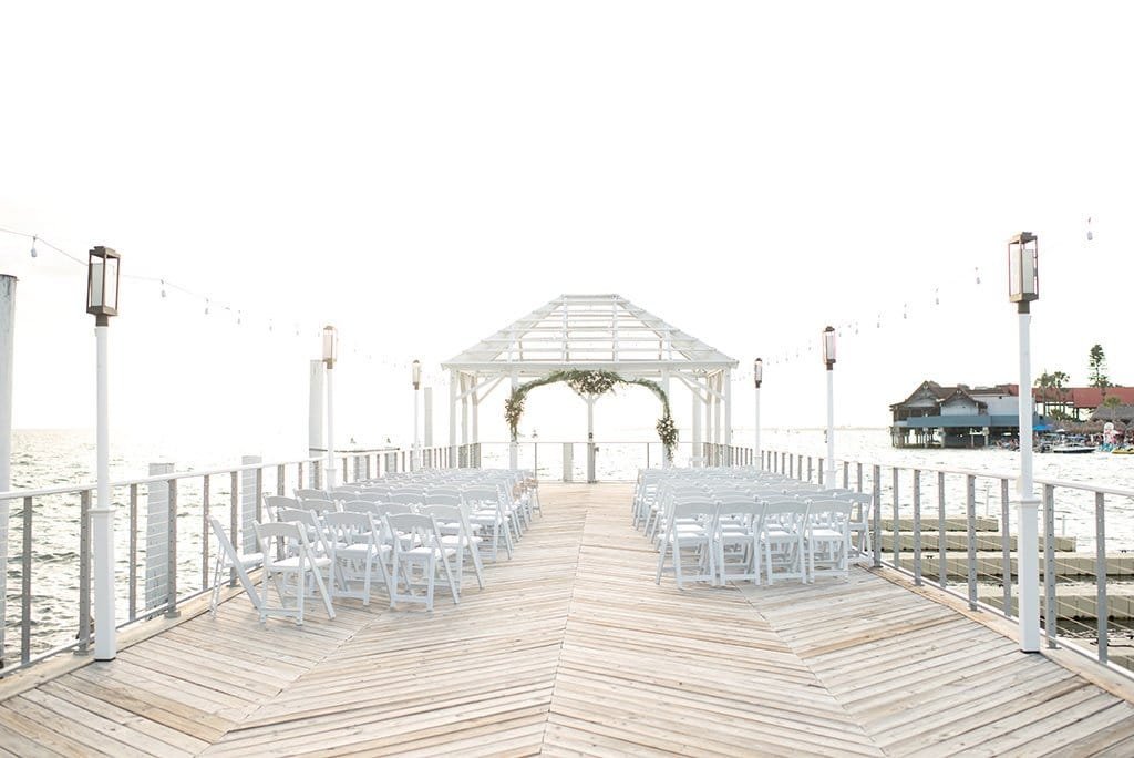 Romantic outdoor beachfront wedding ceremony on the emerald lawn at Sandpearl Resort in Clearwater Beach overlooking the Gulf of Mexico