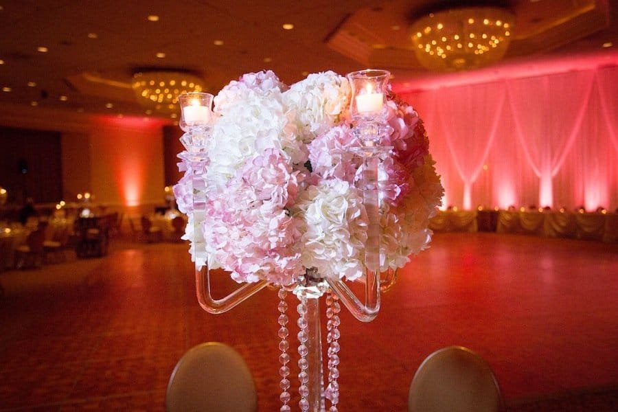Luxury wedding reception tablescape at Innisbrook Resort with tall floral arrangements and crystal chandeliers
