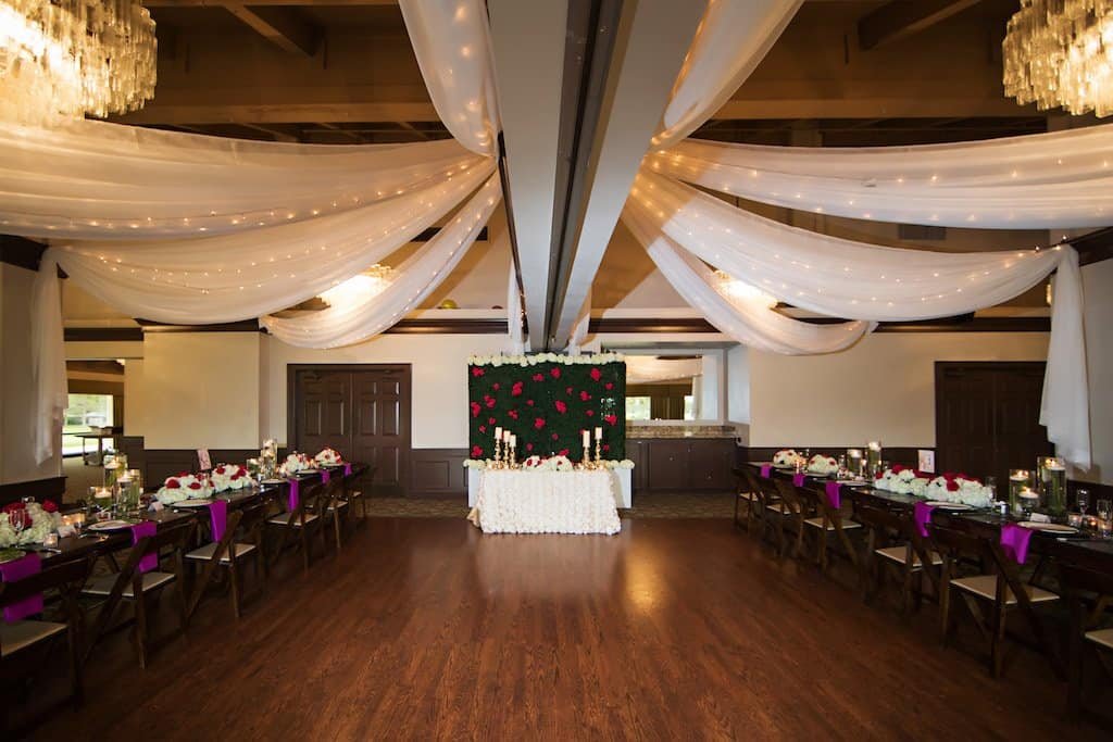 Ballroom Ceiling Draping and String Lights at Countryside Country Club Grand ballroom wedding reception featuring custom white fabric ceiling draping with warm string bistro lighting by Gabro Event Services