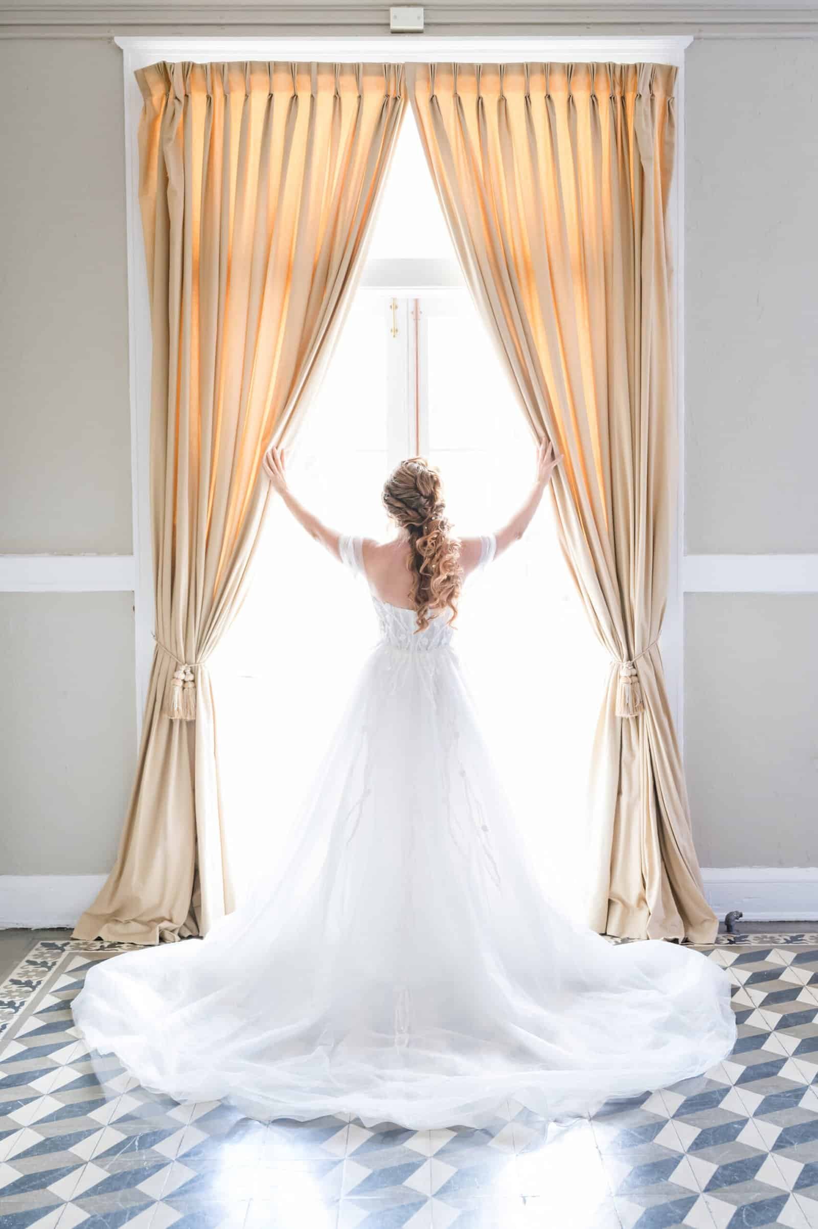 Bride glamour wedding portrait with off-the-shoulder chiffon gown and pearl hairpiece