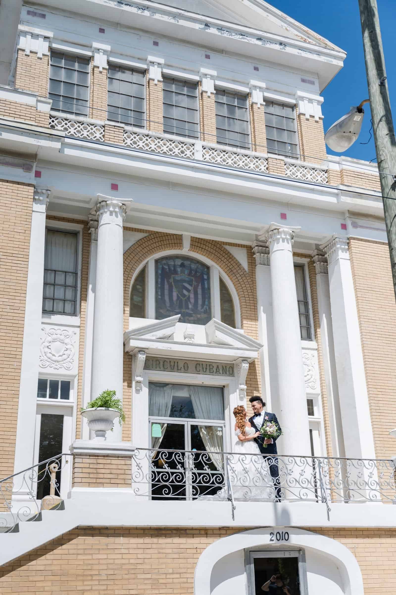 Cuban Club bride and groom wedding portrait in front of the grand neoclassical yellow brick building