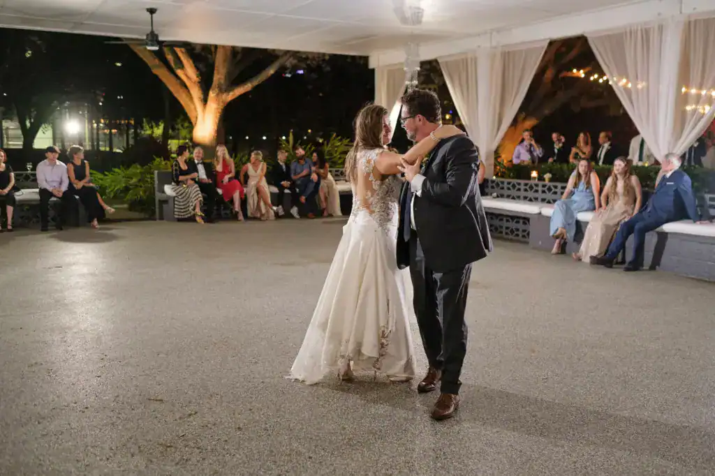 First dance under a white tent with guests seated at the edge at Davis Island Garden Club