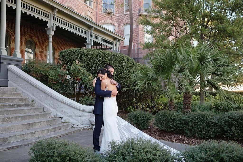 Bride and groom showing off their custom blue Converse and Vans sneakers.