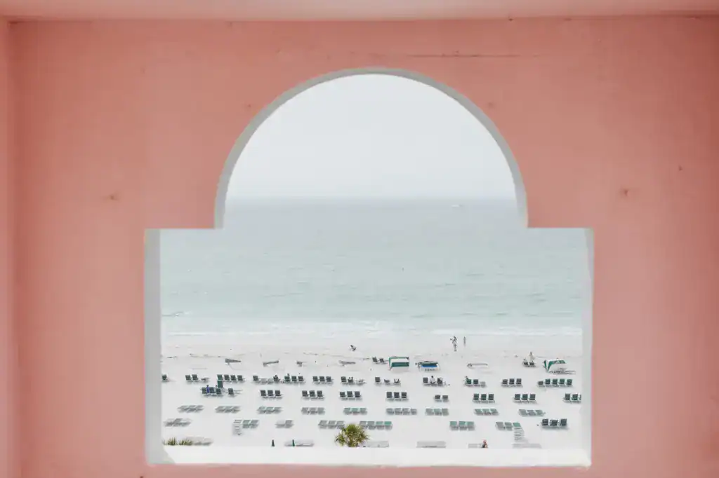 Veranda courtyard ceremony setting with lush floral arch at The Don CeSar