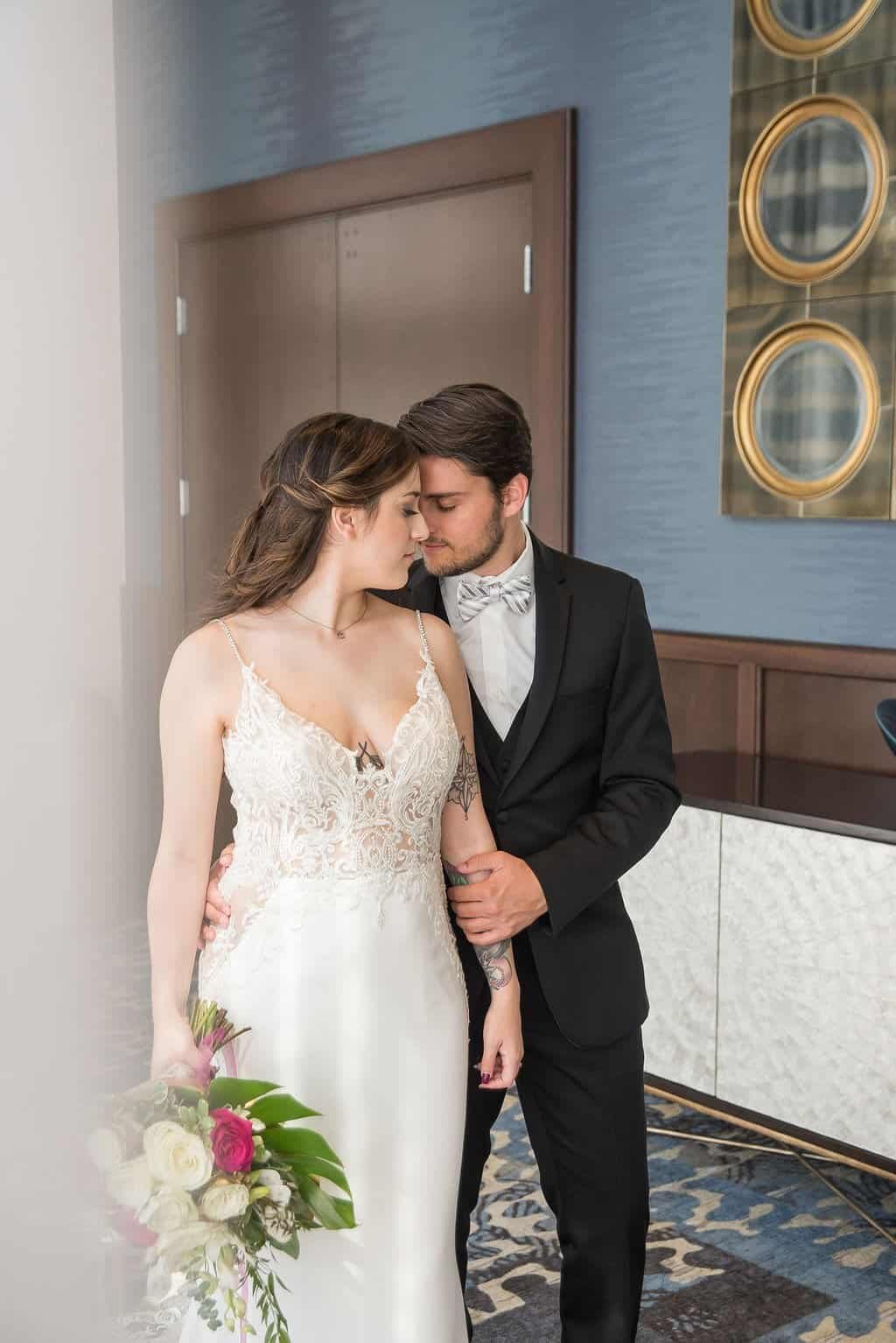 Dramatic wedding ceremony at The Vault in downtown Tampa featuring towering sheer ceiling drapery and grand arched windows