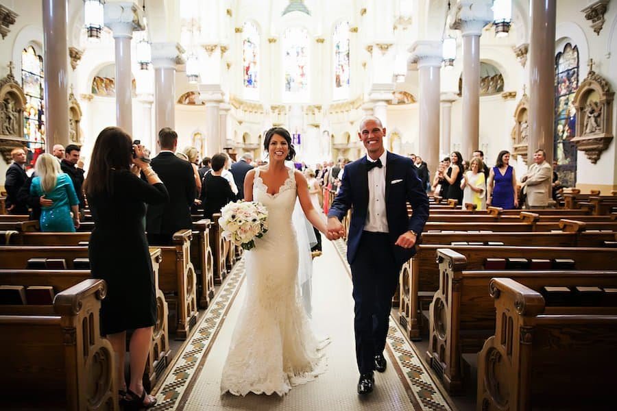 Bride and groom smiling during their elegant downtown Tampa wedding reception celebration.