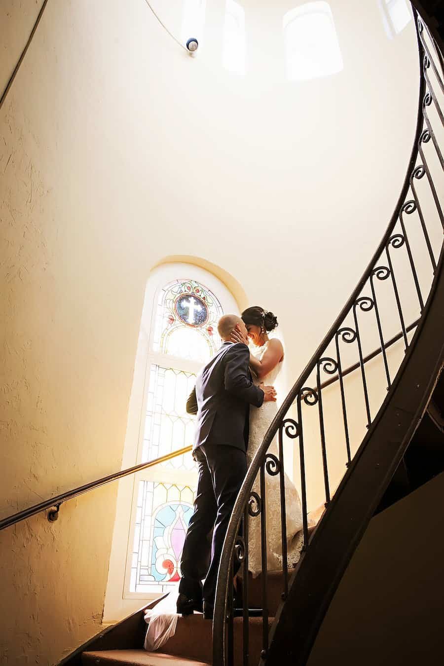 Bride and Groom Posing on Historic Sacred Heart Marble Staircase by Limelight Photography