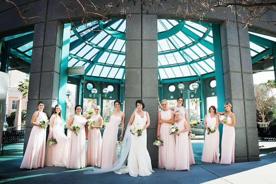 Bridesmaids in Floor Length Blush Pink Gowns Holding White and Rose Floral Bouquets