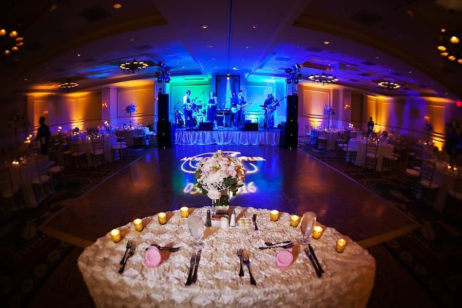 Embassy Suites Ballroom Reception with Custom Dance Floor Monogram and Blue Uplighting by Gabro Event Services