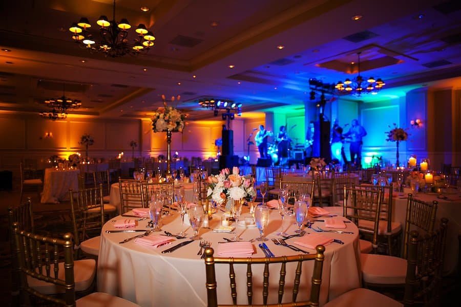 Ballroom Reception Staging with Gold Chiavari Chairs, Custom Monogram and Uplighting by Gabro Event Services