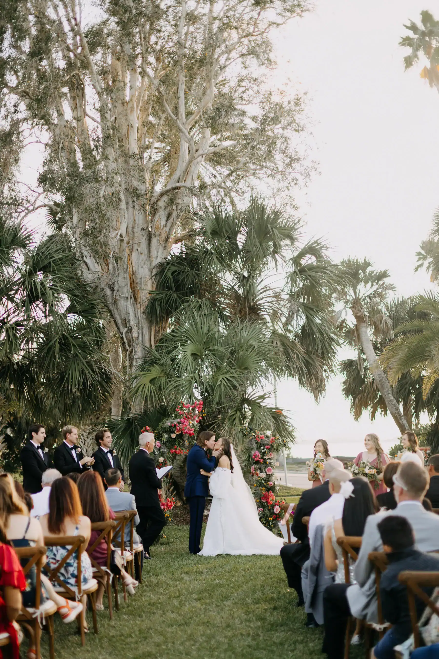 Bride and Groom First Kiss at Floral Altar on The Fenway Lawn by Amber McWhorter Photography
