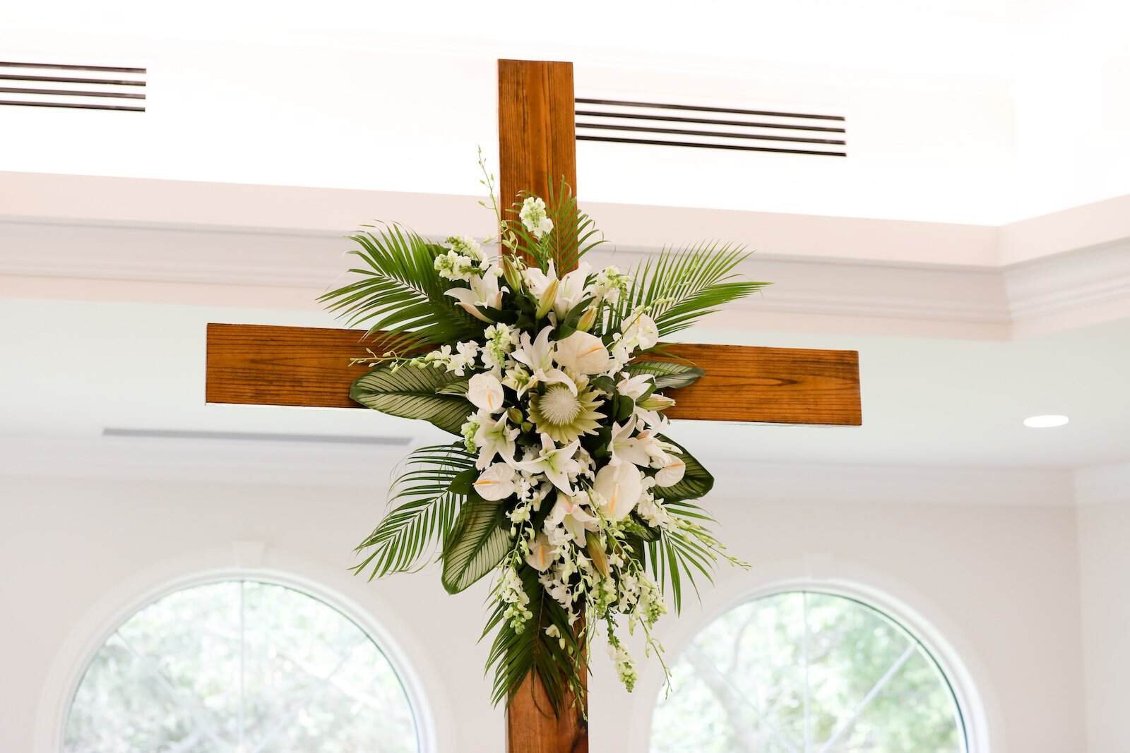 Luminous Harborside Chapel Wedding Ceremony with White Pews, Elegant Chandeliers, and Natural Daylight