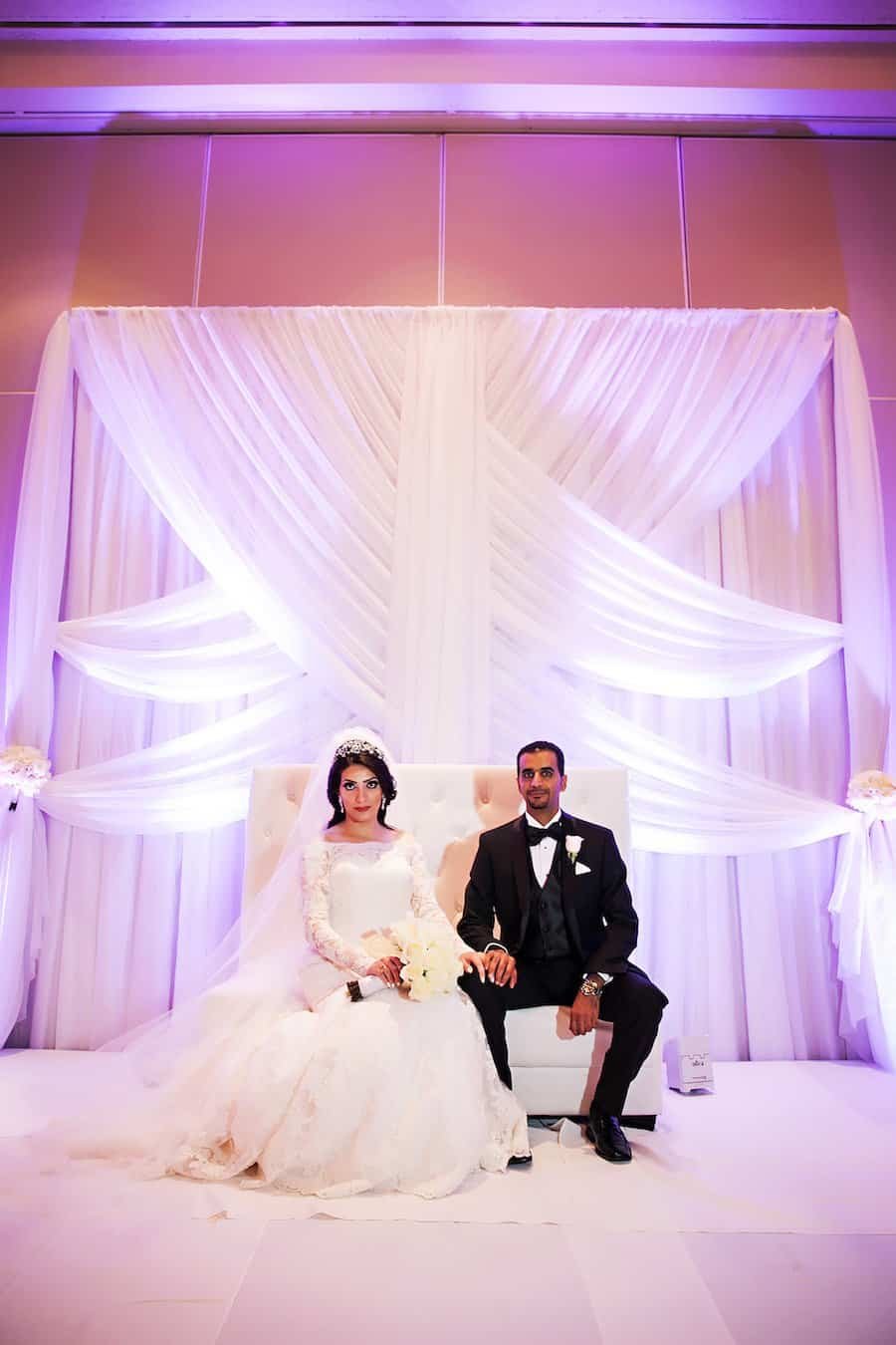 Bride and Groom Ballroom Portrait with Pure White Fabric Backdrop and Uplighting