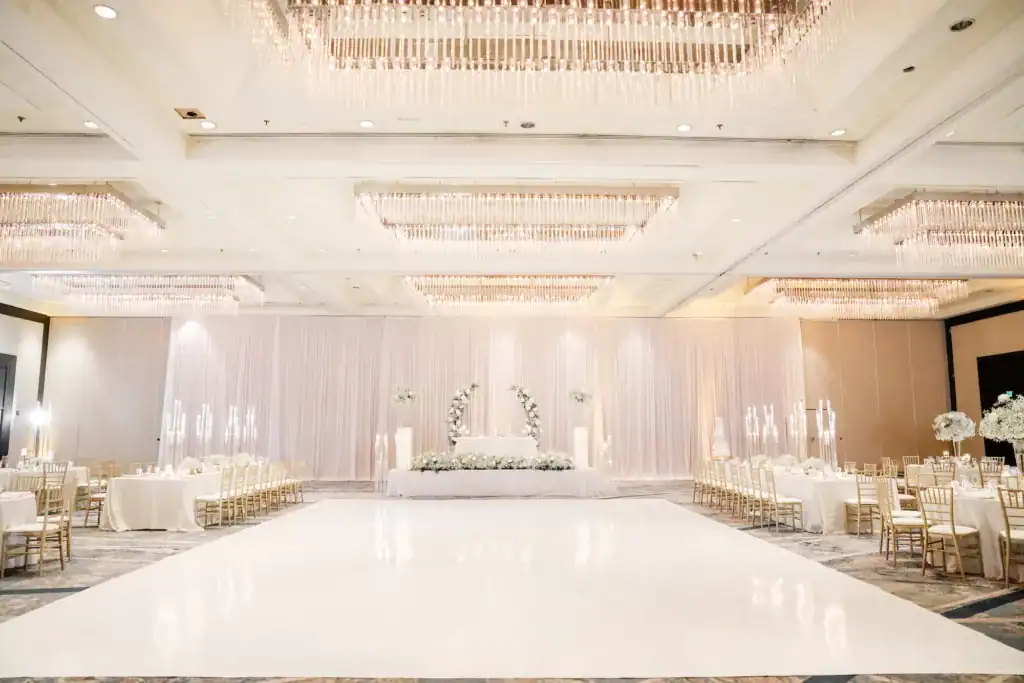 Hilton Tampa Downtown ballroom with a white dance floor at the centre, draped walls and warm uplighting
