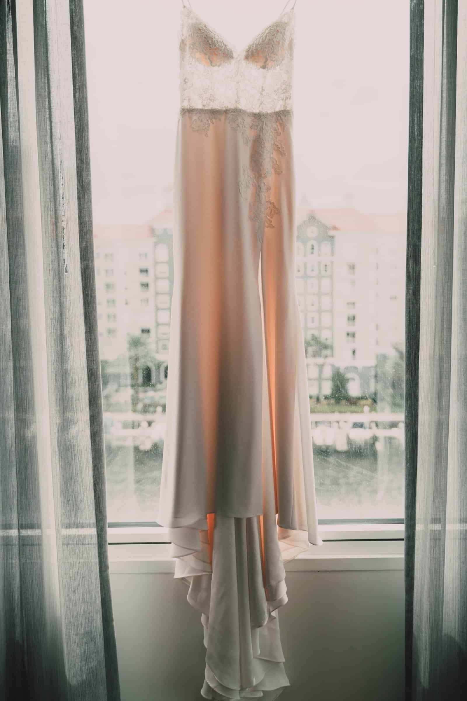 Hotel Alba Poolside Modern Rainbow Ceremony Backdrop with Ombre Florals and Acrylic Ghost Chairs