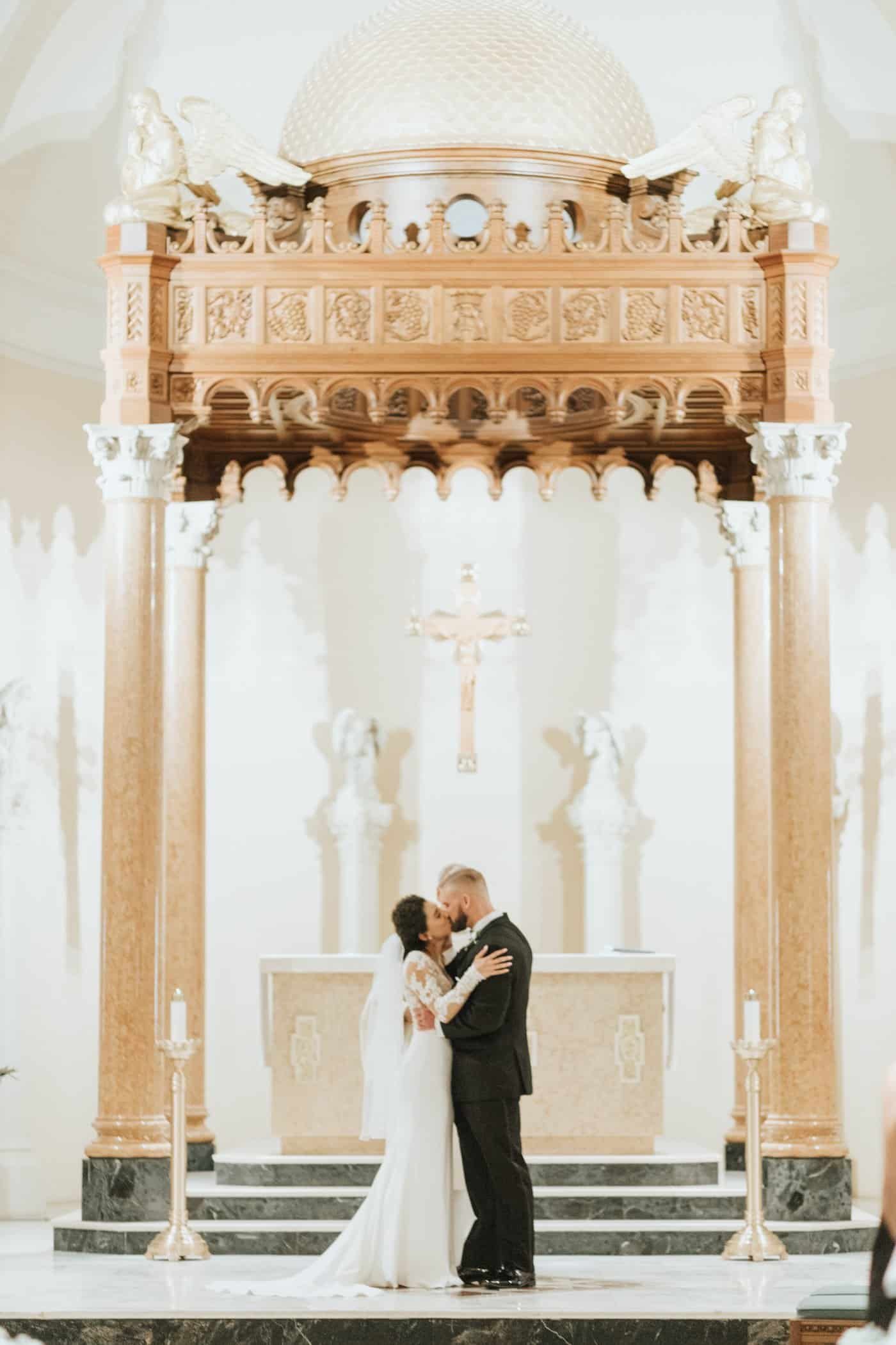 Wedding guests dancing on a glossy floor during a vibrant rooftop reception.