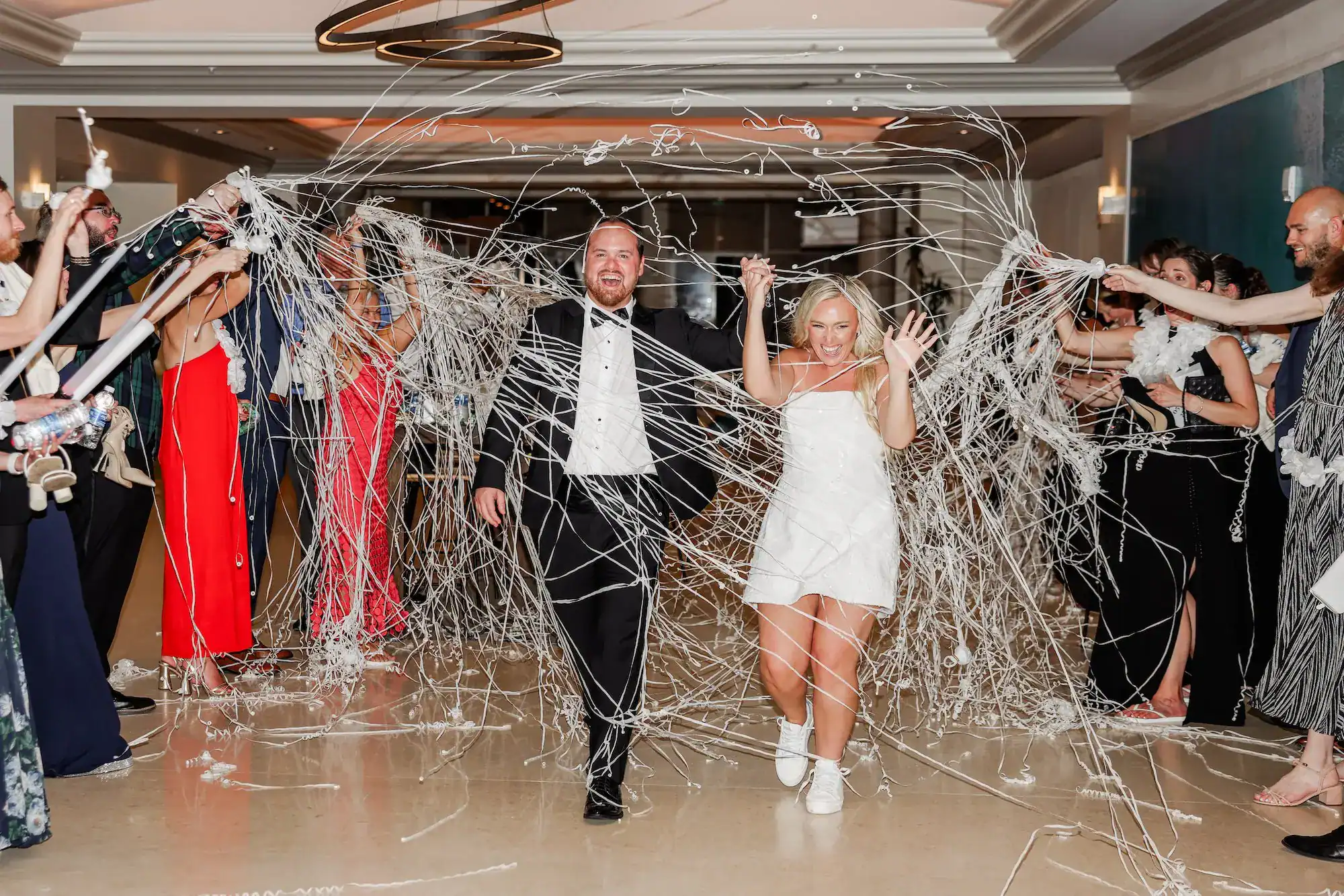 Joyful streamer toss grand exit in the grand hallway of Hyatt Regency Clearwater Beach