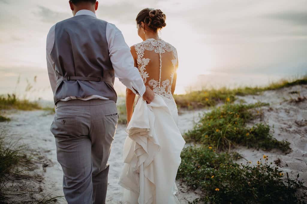 Bride and groom posing during sunset on the white sands of Clearwater Beach outside the Hyatt Regency