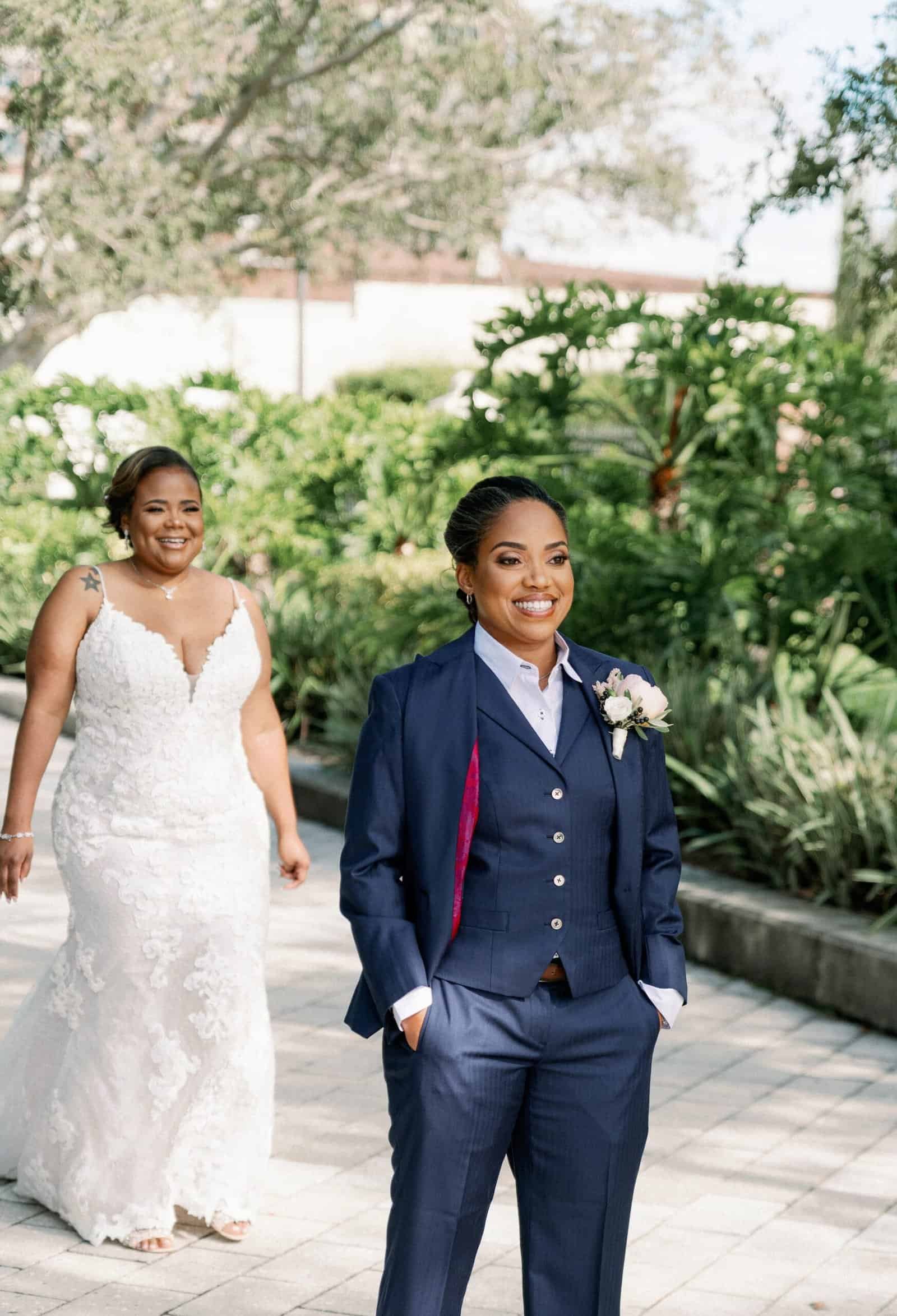Close up of vibrant pink floral arrangements and dusty blue wedding decor elements.