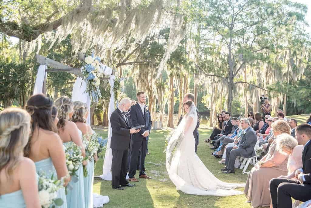 A bride and groom laughing together during their sunset portraits on the golf course.