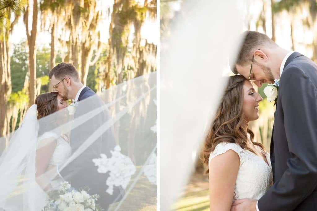 Elegant white reception chairs and white draping behind a romantic sweetheart table.