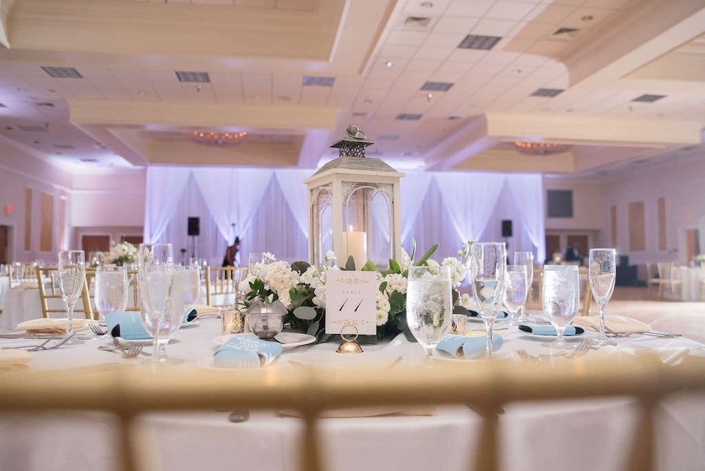 Rustic Wedding Reception Table Decor with White Lantern and Ivory and Greenery Floral Wreath at Innisbrook Ballroom