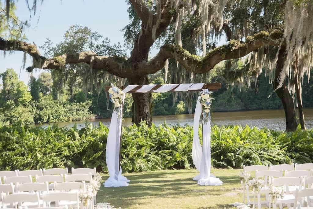 Rustic Wood Wedding Ceremony Arch with White Fabric Draping and Blue and White Florals at Innisbrook Golf and Spa Resort