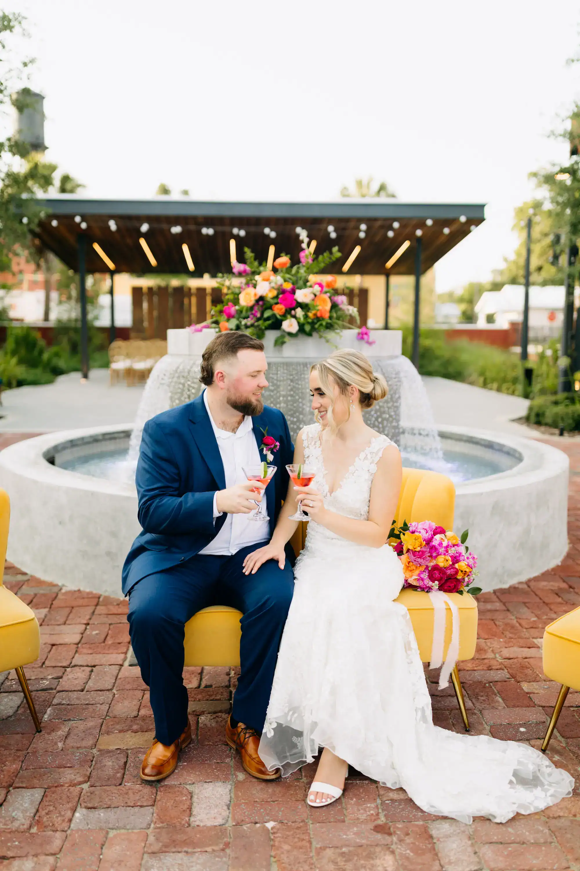 Courtyard fountain wedding portrait with colorful florals at JC Newman