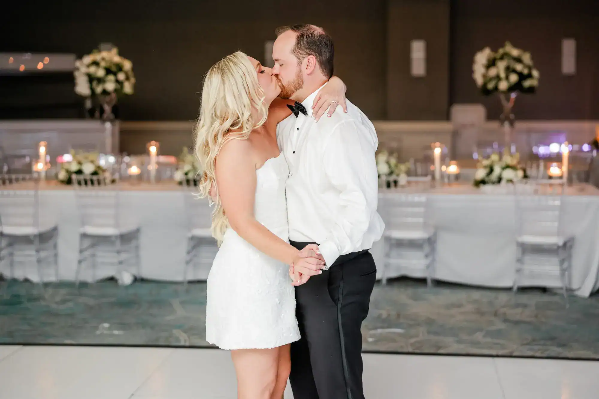 Bride and groom first dance on Gabro Event Services custom white dance floor in Hyatt Regency Grand Ballroom