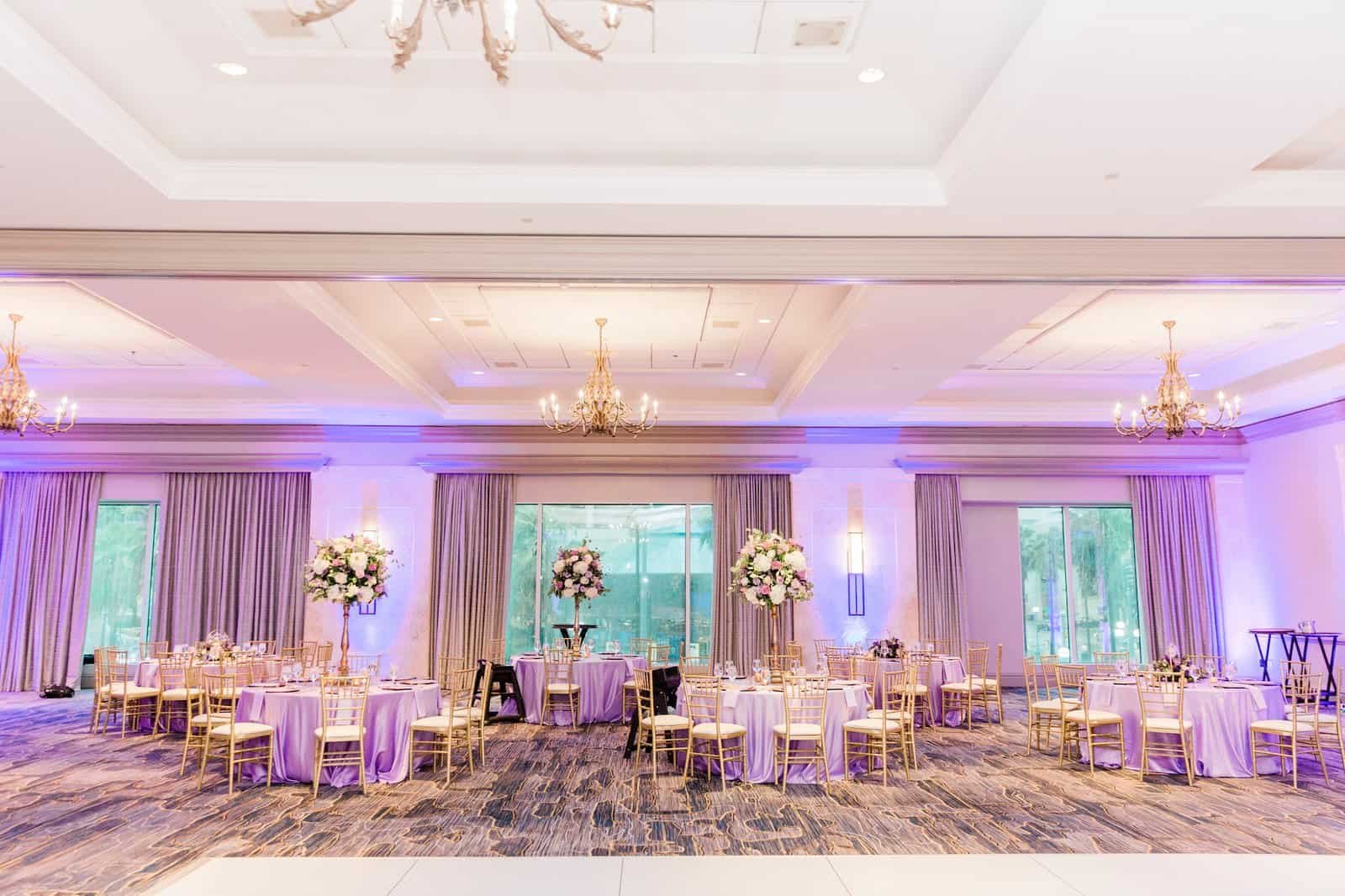 Downtown Tampa ballroom reception overview with lavender tablescapes and ambient purple uplighting