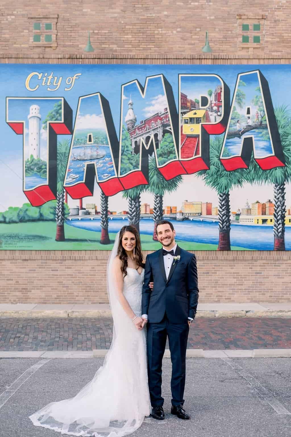 Bride in Sweetheart Lace Gown and Groom on Riverwalk Marina Boardwalk at Tampa Marriott Water Street