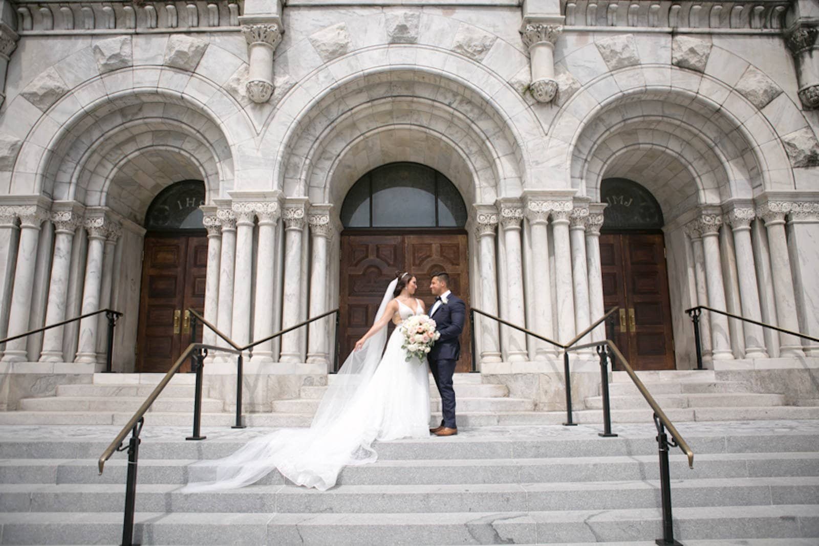 Bride and Groom Portrait on Historic Church Grand Staircase by Carrie Wildes Photography