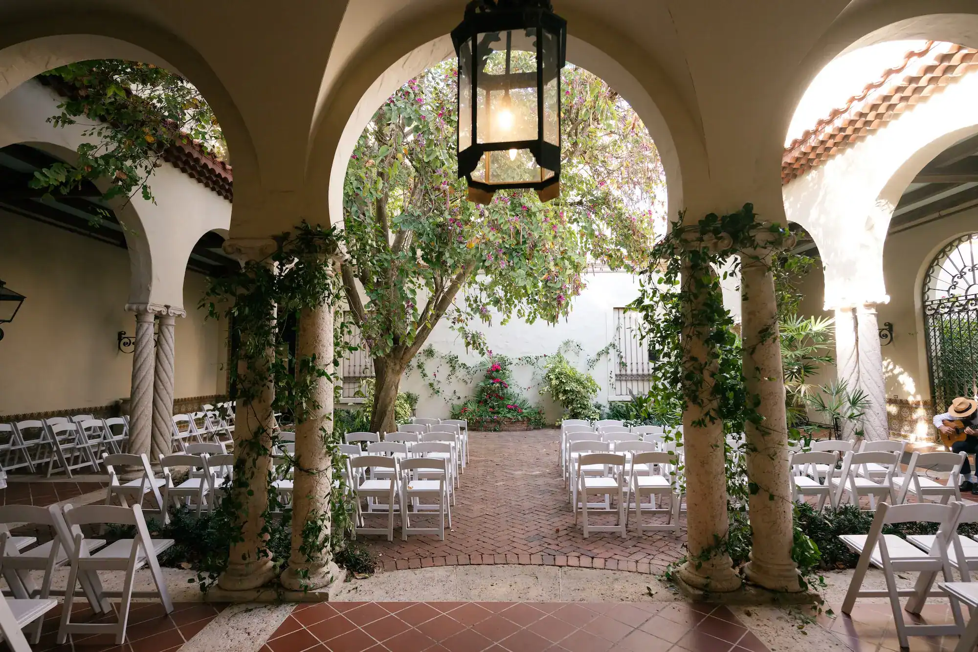 Emerald green and pink tropical wedding ceremony setup at Museum of Fine Arts St Pete overlooking the bay
