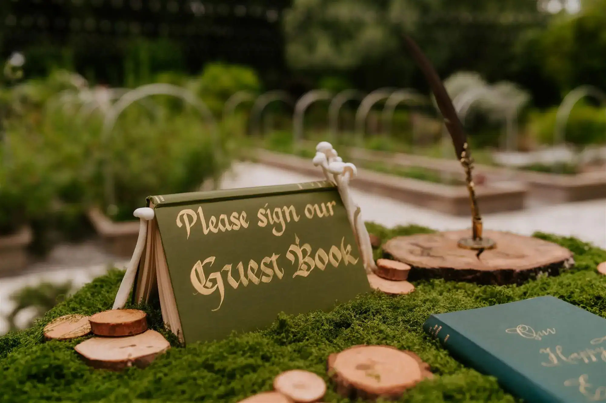 Intimate enchanted forest ceremony clearing framed by organic floral installations at Mill Pond Estate